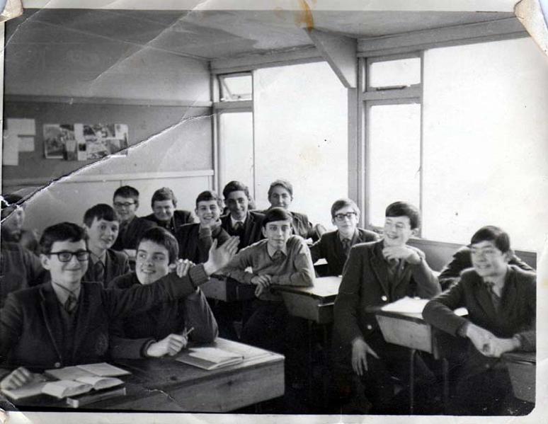 Class c1968.jpg - This photo was taken and developed by Brother Engel. Gerry McBride (who supplied this photo) remembers a number of the names of his fellow pupils and he lists them below from left to right. At the back George Dudgeon at the front Mike? Ross, behind him O'Dwyer behind him at the back Gerry McCabe and Norman Stone. In front them Philip Conti, Gerry McBride Can't remember who is on my left. In front of me Andrew Reidpath. Can't remember names to his left or in front. Lastly Martin Pia. He think this was 68/69Richard Acomb contacted us to say - Its Raymond Ross at the front of class whose left arm is extended under my throat! My face was not obstructed but I do look a little disconcerted!  Behind me is Michael O'Dwyer. Gerry McCabe and Norman Stone at the very back. Philip Contini and Francis Pritchard in front of them. Is that Gerry McBride between Philip Contini and Francis Pritchard? Andrew Redpath to Gerry's front and it is David Gordon to the Andrew Redpath's left hand side. In front of Andrew Redpath is Chris Rogers who is behind Martin Pia.
